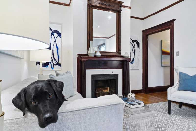 Mr Raffi, the living room and the fire place (which is usable to a limited extent). There's a marble tile mosaic surround, coved ceilings and recessed lighting.