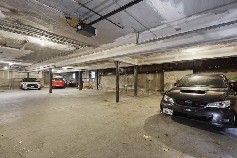 Number 5's parking space is to the right of the Subaru. Note the big steel posts and beams.