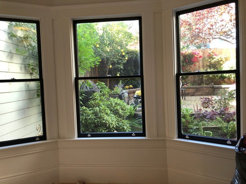 Painting the window frames black and the addition of new hardware updated the entire look of the room without breaking the bank and enhanced the view too.