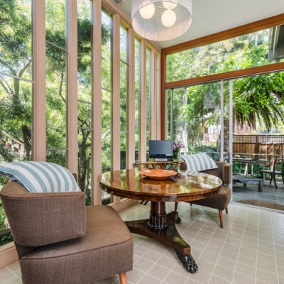 The mid-century breakfast nook opens out directly onto  the lovely deck and receives filtered sunlight most of the day.