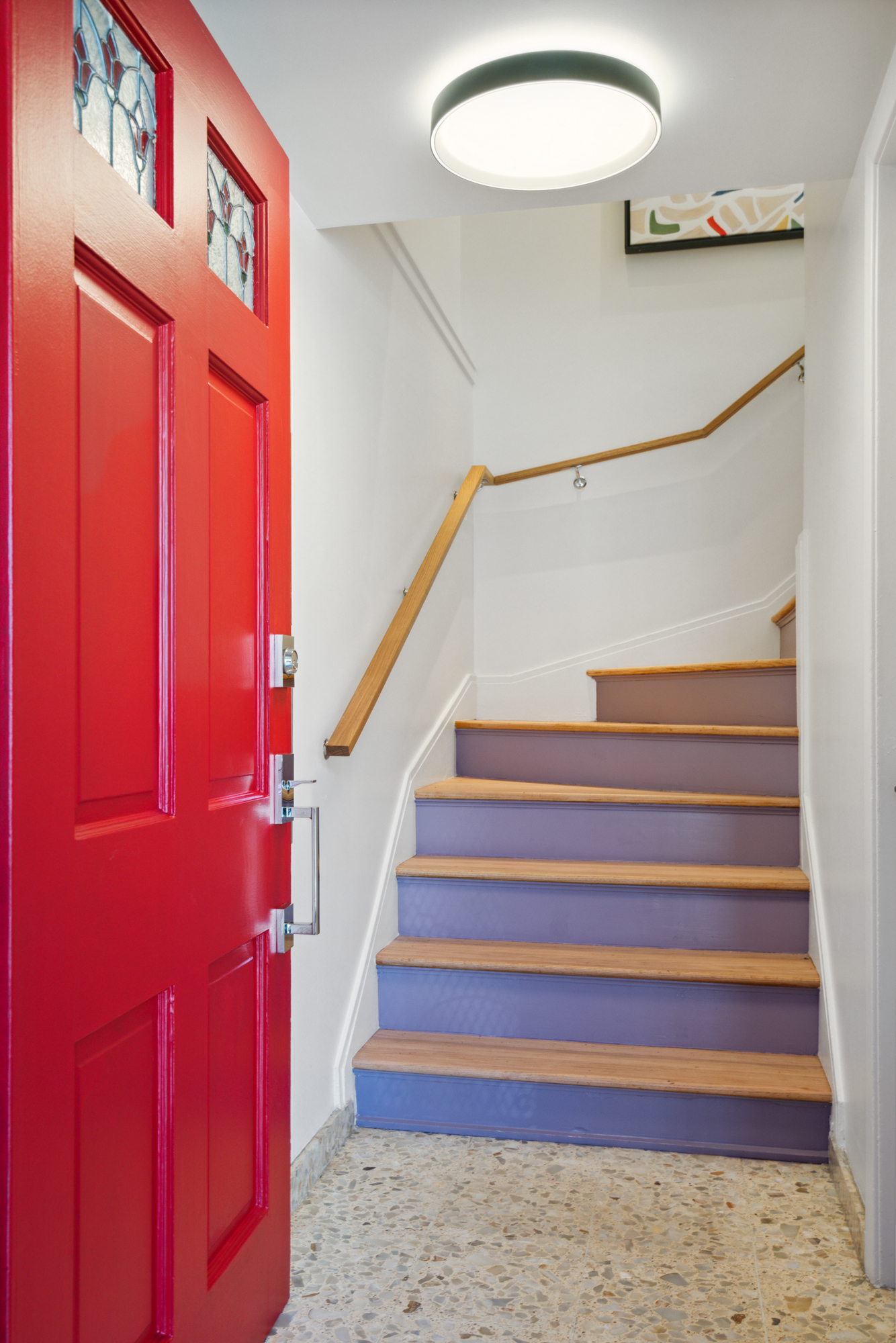 Open red door and stairs leading up