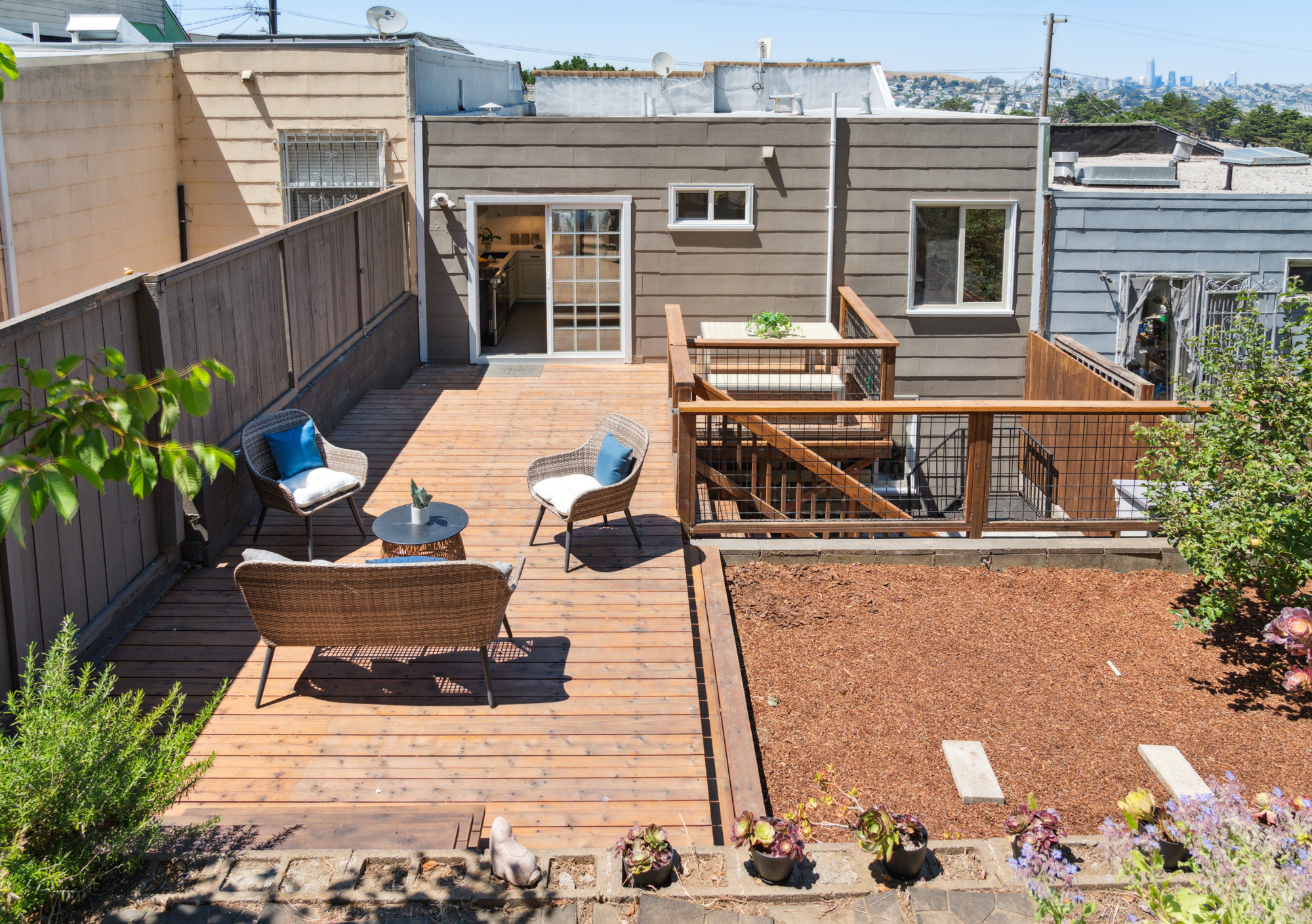 The back of the house with sliding door to kitchen