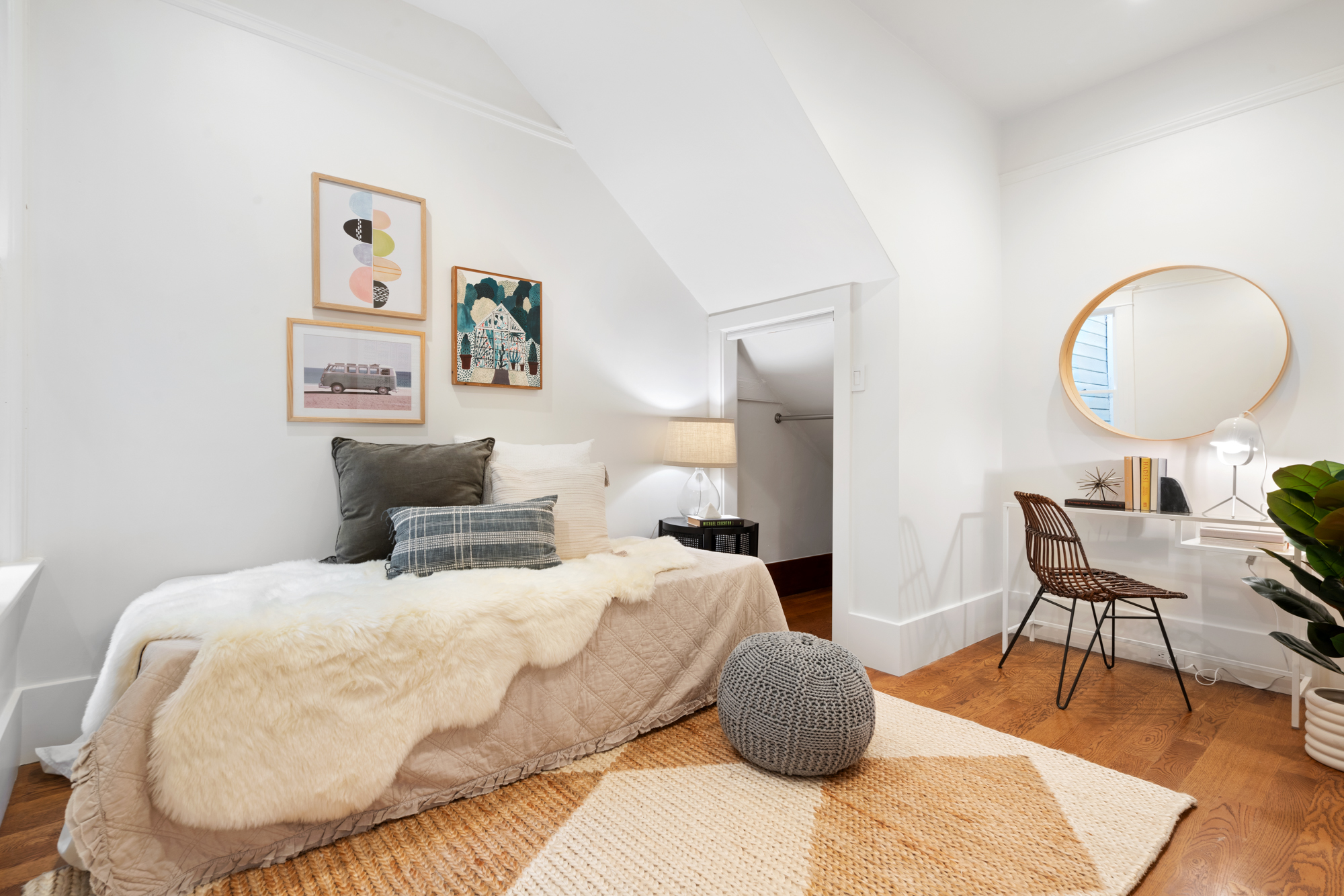 tylish bedroom with frosted glass sliding doors, modern lighting fixtures, round accent mirror, and cozy decor.