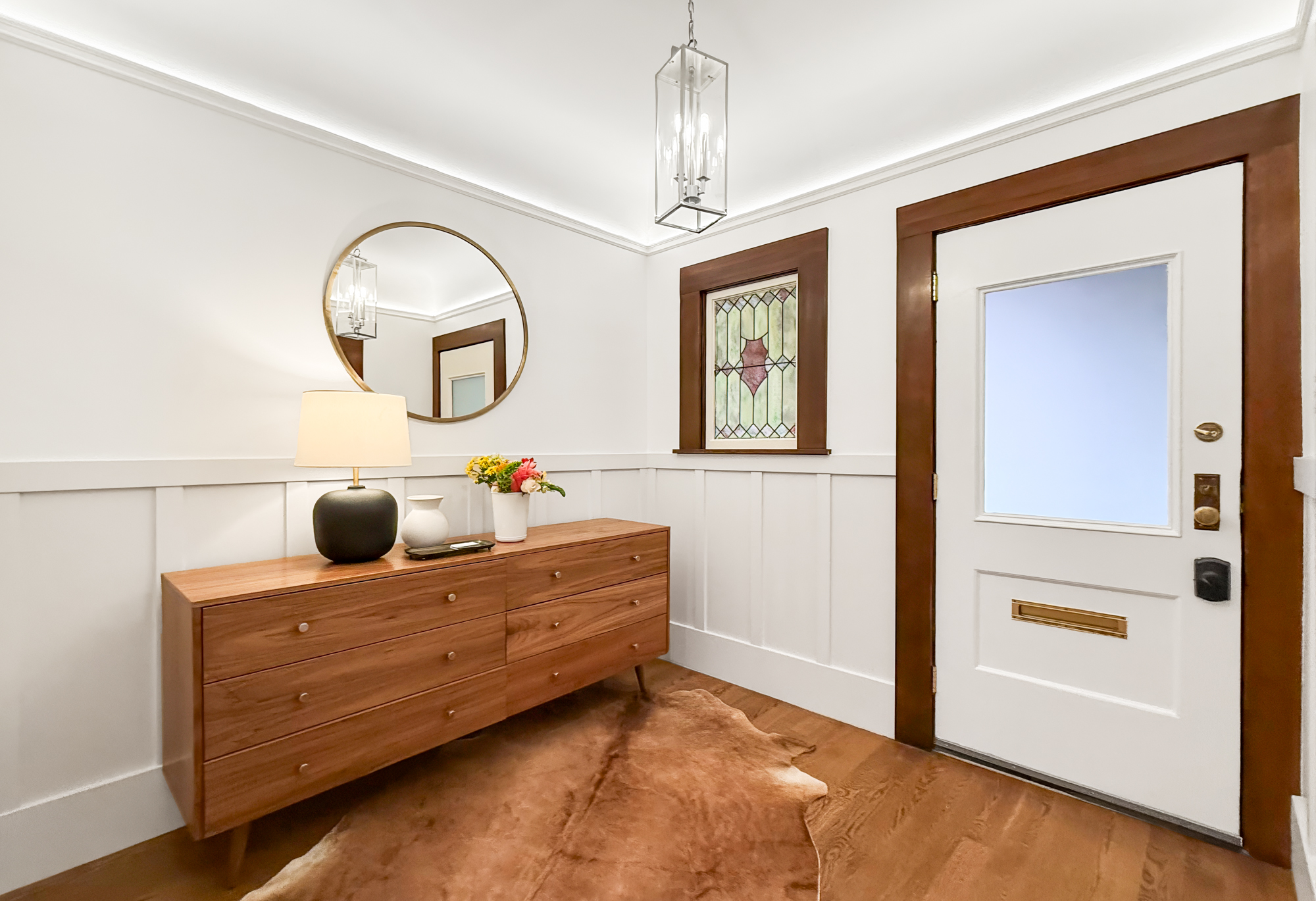 Welcoming entry foyer at 4255 24th Street featuring elegant wood details, modern lighting, stained glass accent, and tasteful décor.