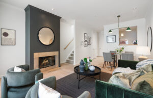 Open living room with integrated fireplace and dining area at 500 Masonic #8.